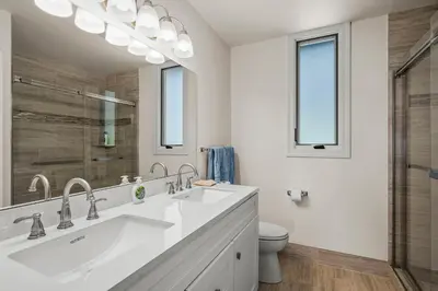 a white bathroom with two sinks and a toilet at Newley remodeled, two story, two-bedroom condo nothing but Views of Lake Tahoe! in Incline Village
