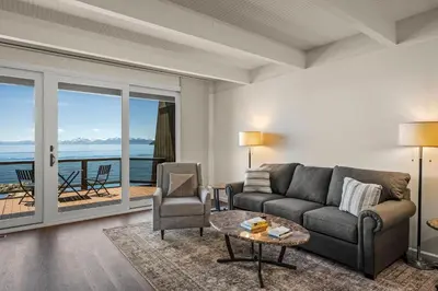 a living room with a couch and a table at Newley remodeled, two story, two-bedroom condo nothing but Views of Lake Tahoe! in Incline Village