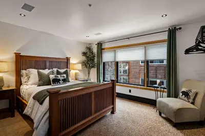 a bedroom with a bed and a chair and a window at Third Creek- Experience the Ultimate in Luxury in Incline Village