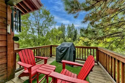 two red chairs and a table on a deck at Third Creek- Experience the Ultimate in Luxury in Incline Village