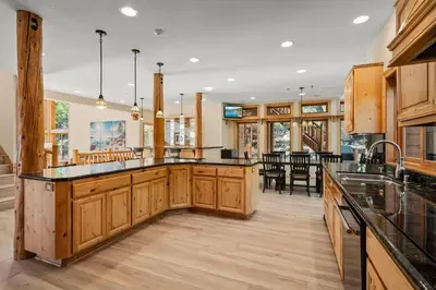 a kitchen with wooden cabinets and a large island at Do not miss your chance to vacation at this five bedroom 5 bath mountain home in Incline Village
