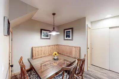 a dining room with a wooden table and chairs at Crestview 48 in Mammoth Lakes