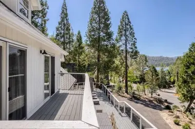 a porch of a house with a railing at Luxury Lake Home-The Bear Claw-Boat Slip-Sleeps 16 in Bass Lake