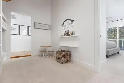 a white room with a table and a chair at Luxury Lake Home-The Bear Claw-Boat Slip-Sleeps 16 in Bass Lake
