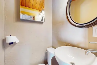 a bathroom with a sink and a mirror and a toilet at Mountain Serenity, near Ski, Golf, Casino, Lake in Stateline