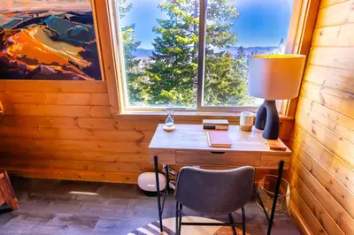 a desk with a lamp and a chair in front of a window at Mountain Serenity, near Ski, Golf, Casino, Lake in Stateline
