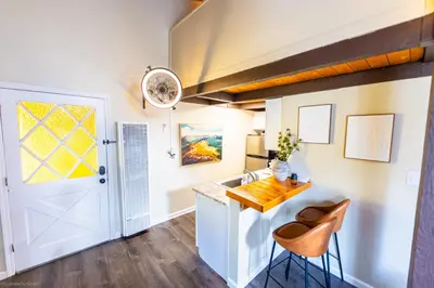 a kitchen with a sink and a counter with two stools at Mountain Serenity, near Ski, Golf, Casino, Lake in Stateline