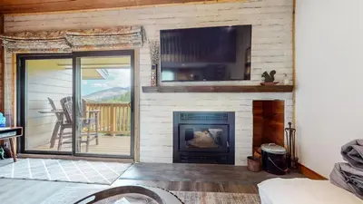 a living room with a fireplace and a tv at Snowcreek II #220 condo in Mammoth Lakes