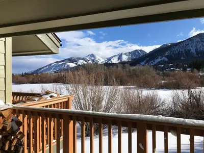 a view from the porch of a house with snow covered mountains at Snowcreek II #220 condo in Mammoth Lakes