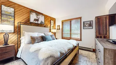 a bedroom with a bed and a desk and a window at Snowcreek II #220 condo in Mammoth Lakes