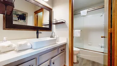 a bathroom with a sink and a toilet and a mirror at Snowcreek II #220 condo in Mammoth Lakes