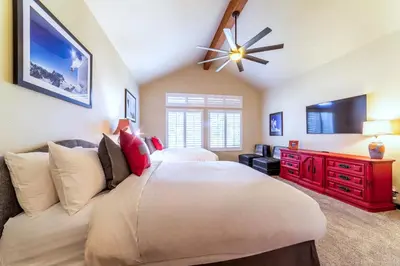 a bedroom with a large bed and a ceiling fan at Grand Townhome w/ Meadow Views; Private Garage in Mammoth Lakes