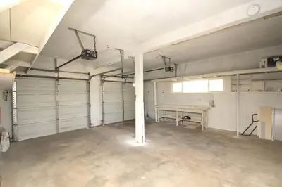 a garage with white walls and a table in it at Entire House in Old Fig Garden in Fresno