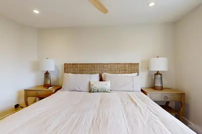 a bedroom with a large white bed with two lamps at Towering Pine in Incline in Incline Village