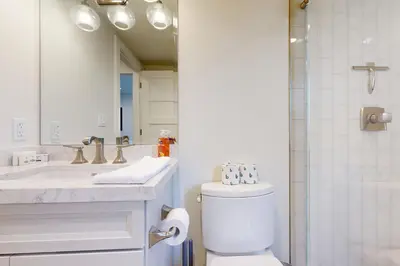 a bathroom with a toilet and a sink and a mirror at Towering Pine in Incline in Incline Village