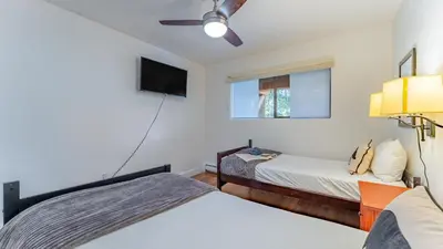 a bedroom with two beds and a flat screen tv at Walk to Lake DiningShops 5mins to Ski Resort Incline Paradise by AvantStay in Incline Village