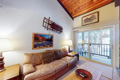 a living room with a couch and a large window at Chamonix 36 in Mammoth Lakes