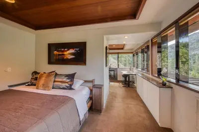 a bedroom in a house with a bed and a bathroom at Spire Chalet at Alpine Meadows - 4BR W Hot Tub and Ski Shuttle in Alpine Meadows