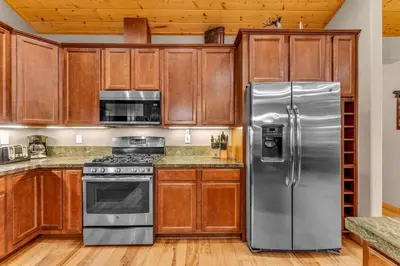 a kitchen with wooden cabinets and stainless steel appliances at Kings Beach Retreat, Hot Tub, Walk to Beach in Kings Beach