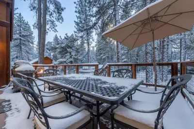 a table and chairs on a deck in the snow at Kings Beach Retreat, Hot Tub, Walk to Beach in Kings Beach