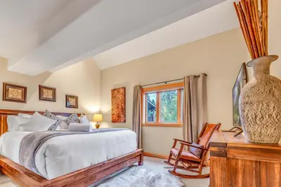 a bedroom with a bed and a desk and a window at Secluded Tahoe Retreat by Northstar with Hot Tub in Truckee