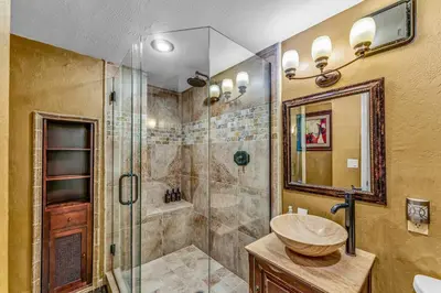 a bathroom with a glass shower and a sink at Secluded Tahoe Retreat by Northstar with Hot Tub in Truckee