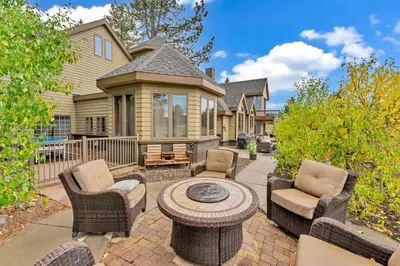 a patio with chairs and a table in front of a house at Secluded Tahoe Retreat by Northstar with Hot Tub in Truckee