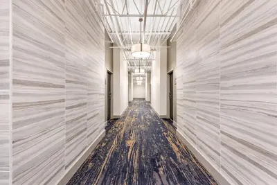 a hallway with white walls and a long aisle at The Federal Hotel Downtown Carson City, an Ascend Collection Hotel in Carson City