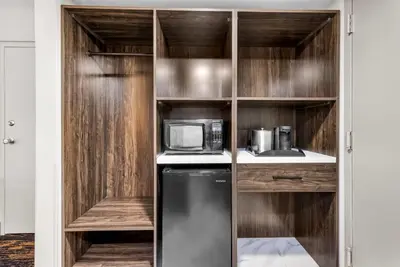 a kitchen with a black refrigerator and a microwave at The Federal Hotel Downtown Carson City, an Ascend Collection Hotel in Carson City