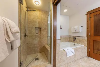 a bathroom with a shower and a bath tub with a shower at Iron Horse Lodge South 408 by East West Hospitality in Truckee