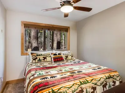 a bedroom with a bed and a ceiling fan at Luxury Single Level, Great Location, Hot Tub, Arcade in South Lake Tahoe