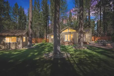 a house in the middle of a yard with trees at Luxury Single Level, Great Location, Hot Tub, Arcade in South Lake Tahoe