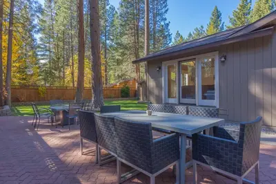 a patio with a table and chairs and trees at Luxury Single Level, Great Location, Hot Tub, Arcade in South Lake Tahoe