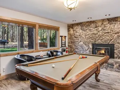 a pool table in a room with a fireplace at Luxury Single Level, Great Location, Hot Tub, Arcade in South Lake Tahoe