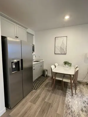 a kitchen with a table and a stainless steel refrigerator at Cozy-Quiet-Spacious Guest Suite in Fresno Clovis California in Fresno