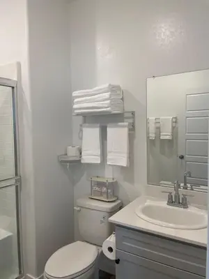 a white bathroom with a toilet and a sink at Cozy-Quiet-Spacious Guest Suite in Fresno Clovis California in Fresno