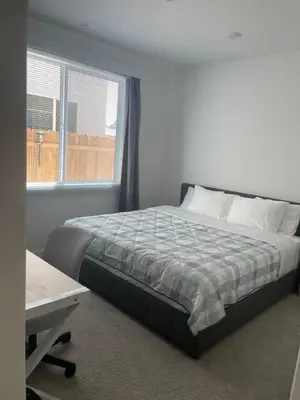 a bedroom with a bed and a window and a desk at Cozy-Quiet-Spacious Guest Suite in Fresno Clovis California in Fresno