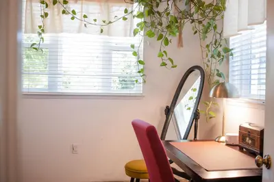 a dining room with a table and a mirror at 1 BR Orchard Cottage - Gateway to Two National Parks! in Visalia