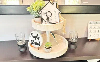 a shelf with a house and a sign on a table at Beautiful Home & Pool in Fresno