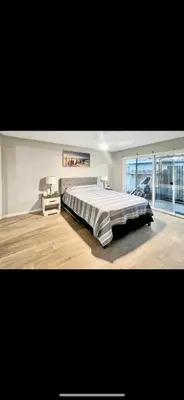 a large bedroom with a large bed and a large window at Beautiful Home & Pool in Fresno