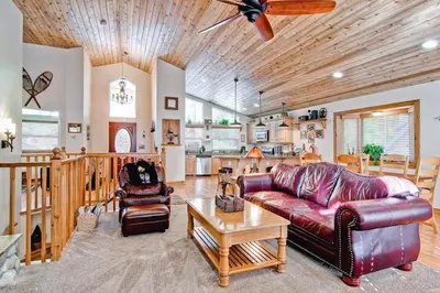 a living room with a couch and a table at Serenity Pines in Yosemite West