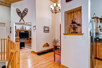 a kitchen and living room with a large refrigerator at Serenity Pines in Yosemite West