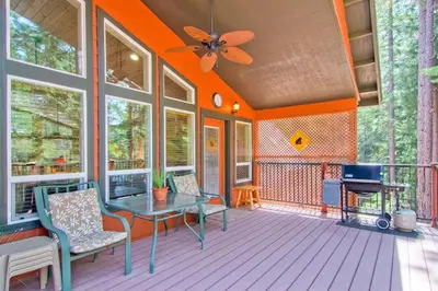 a room with a table and chairs on a porch at Serenity Pines in Yosemite West