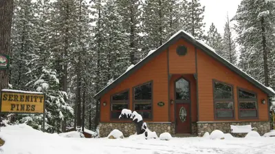 a small cabin in the woods in the snow at Serenity Pines in Yosemite West