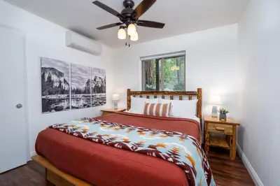 a bedroom with a bed and a ceiling fan at Yosemite Summit & Little Summit in Yosemite West