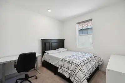 a bedroom with a bed and a desk and a window at Spacious 3BR Home with Charming Backyard home in Folsom