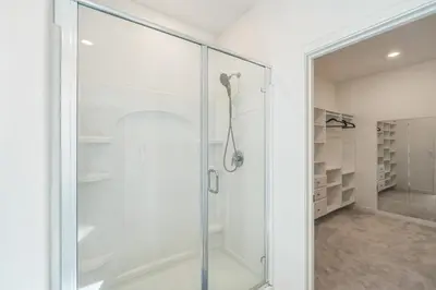 a glass shower door in a bathroom with a walk in closet at Spacious 3BR Home with Charming Backyard home in Folsom