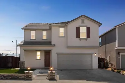 a large white house with a garage at Spacious 3BR Home with Charming Backyard home in Folsom
