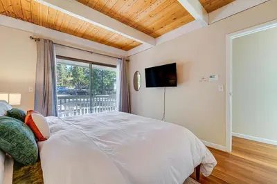 a bedroom with a large bed and a window at 5 Mi to Northstar Skiing Bear Den Home with Decks in Kings Beach