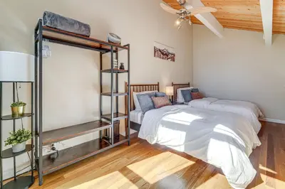 a bedroom with two beds and a fan at 5 Mi to Northstar Skiing Bear Den Home with Decks in Kings Beach
